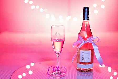 white labeled glass bottle near wine glass thumbnail