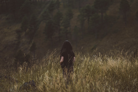 woman standing in the middle of grass thumbnail