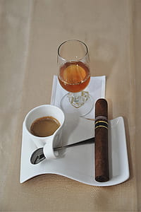 mug with brown liquid and cigar on curved plate thumbnail