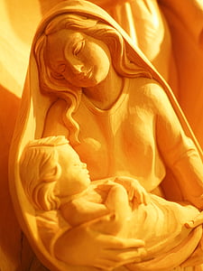 photo of woman holding child figurine thumbnail