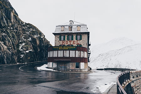 Hotel in middle of road beside mountain thumbnail