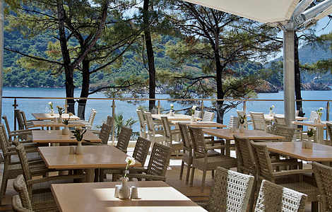 table and chair set near body of water thumbnail