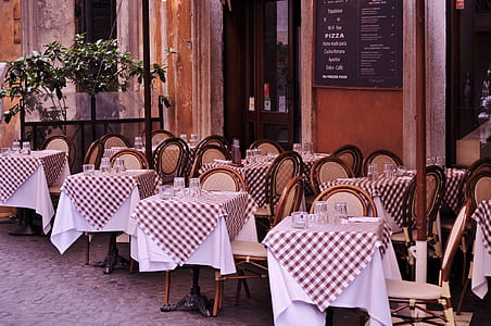 tables and chairs in front of cafe thumbnail