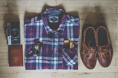 purple, white, and black button-up collard tops, pair of brown leather boat shoes, assorted keys and brown leather wallet thumbnail