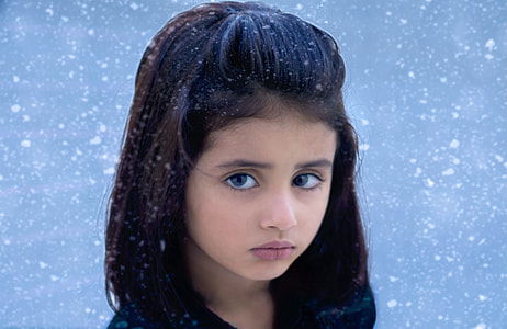girl outside during snow storm photography thumbnail