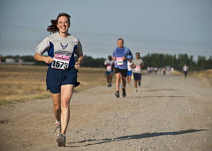 woman in grey shirt running on marathon thumbnail
