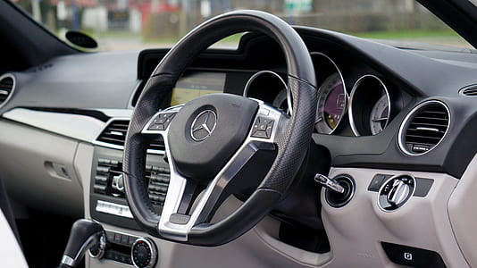 black and grey Mercedes-Benz multi-function steering wheel thumbnail