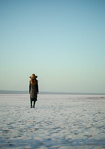 woman in black dress standing on sand thumbnail