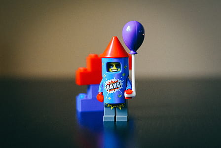 macro photography of blue and red Lego toy on top of table thumbnail