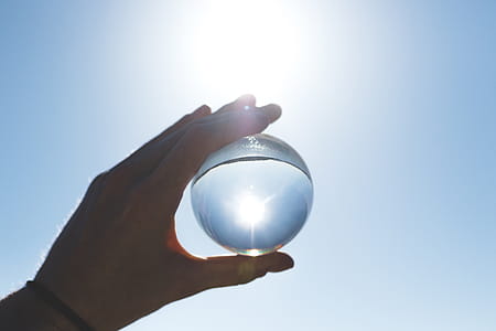 Person Holding Clear Glass Ball thumbnail