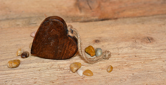 heart-shaped brown wooden keychain on brown surface thumbnail