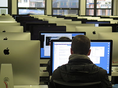 man wearing black top in front of silver iMac thumbnail