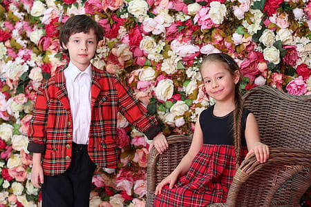 boy standing beside girl sitting on armchair thumbnail