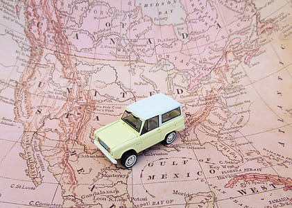 beige SUV miniature on world map thumbnail