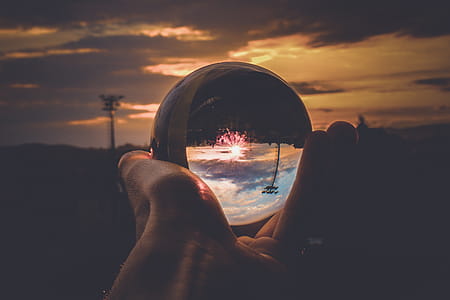 Person Holding Clear Glass Ball thumbnail