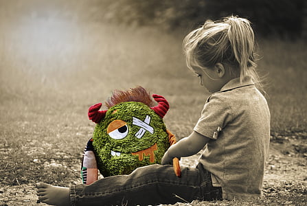 girl sitting on ground near grass field thumbnail