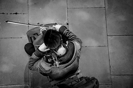 grayscale photo of man playing string instrument thumbnail