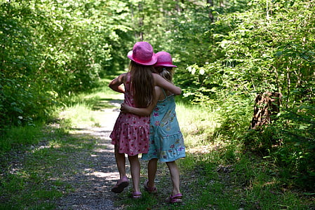 two girl's standing on green grass during daytime thumbnail