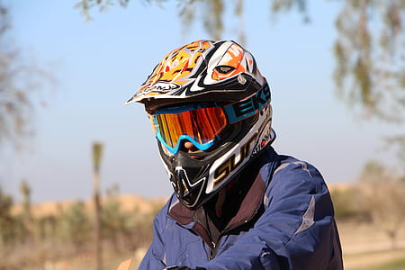 person wearing multicolored motocross helmet thumbnail