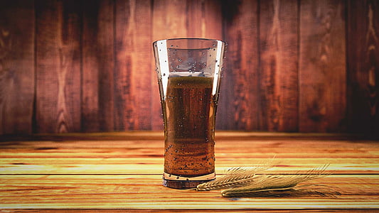 clear pilsner glass with brown liquid inside thumbnail