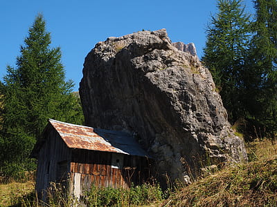 shed beside rock boulder thumbnail