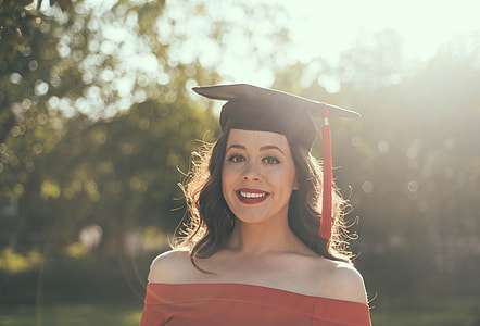 woman smiling wearing academic hat outdoors thumbnail
