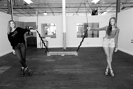 two women holding swing in grayscale photography thumbnail