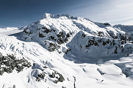 photo of mountain covered by snow under blue sky at daytime thumbnail