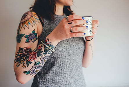 woman standing while holding white mug thumbnail