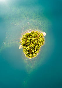 green island surrounded by body of water thumbnail