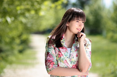 selective focus photography of woman putting her left hand on her chin while looking left thumbnail