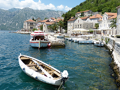 several boats on body of water near houses under white cloudy skies at daytime thumbnail