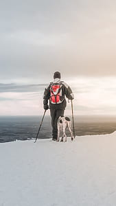man wearing black jacket near dog thumbnail