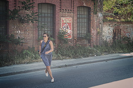 Woman in Blue Tank Dress Running on Road thumbnail