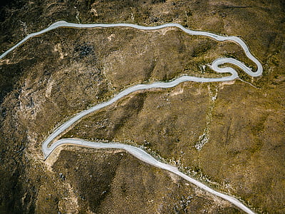 aerial photography of curved winding road thumbnail