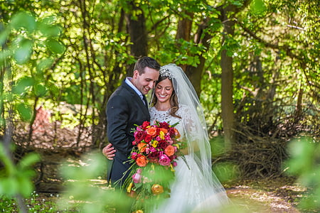 selective focus photography of groom and bride in the middle of forest thumbnail