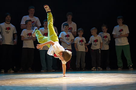 boy performing brake dance surround by people thumbnail