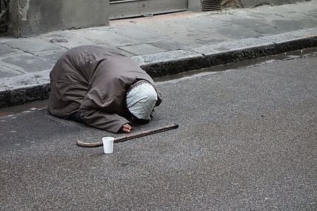 woman kneeling on gray concrete road thumbnail