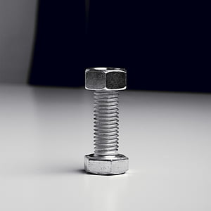 gray bolt and nut on white surface thumbnail