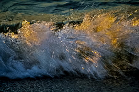 long exposure photography of water crashing stones thumbnail