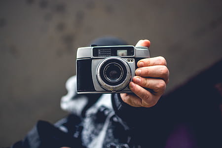 Person Holding Gray and Black Slr Camera thumbnail