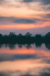 body of water under orange cloudy sky thumbnail