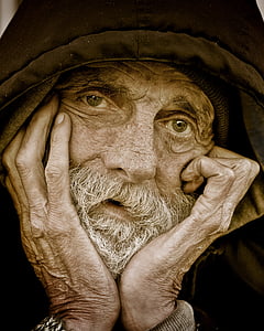 man wearing black hoodie with hands on face thumbnail