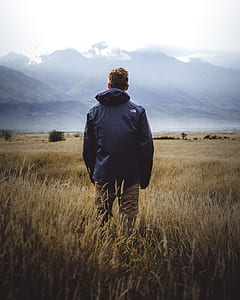 man standing on green field thumbnail
