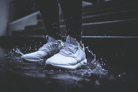person wearing pair of white low-top sneakers thumbnail