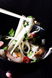Chopsticks holding seafood noodles thumbnail