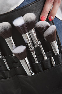 person touching case with makeup brushes thumbnail