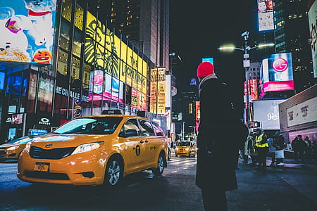 person wearing coat standing on street thumbnail