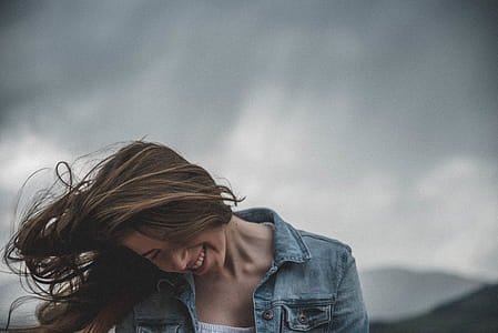 Woman Wears Blue Denim Top and White Inner Smiling thumbnail