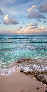 teal seawave under blue and white sky thumbnail